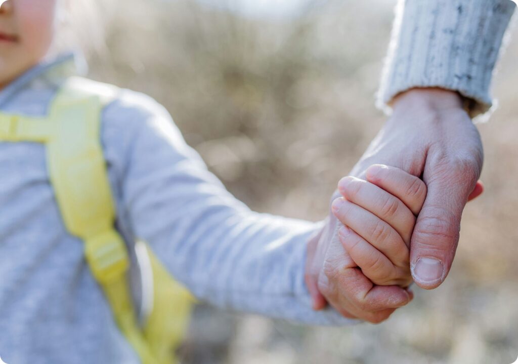 Father and son holding hands while walking together, capturing a moment of connection and care